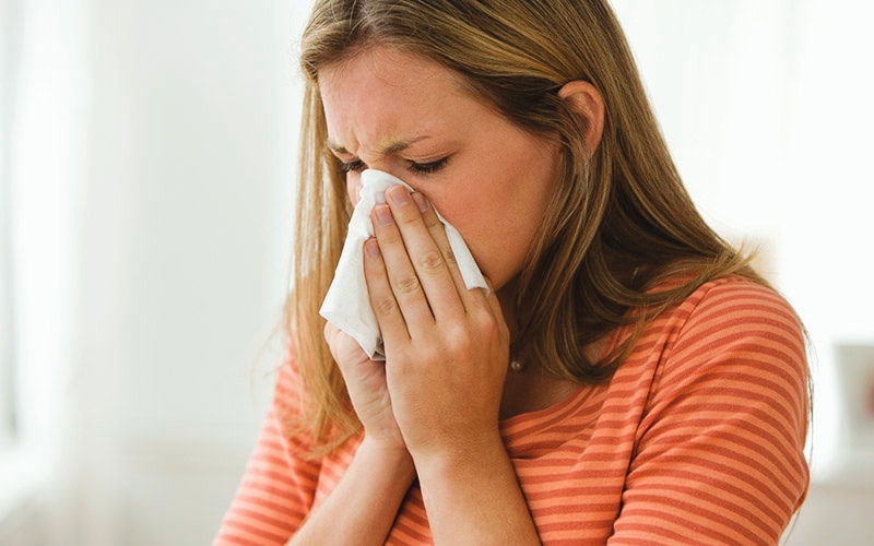 woman sneezing