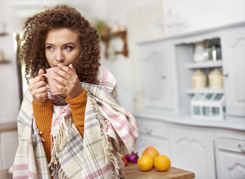 Person Wrapped In Blanket Drinking Coffee