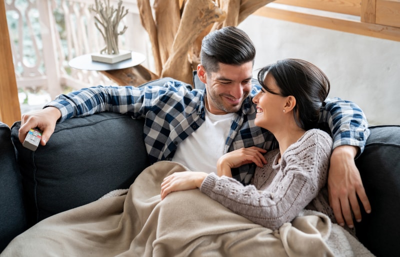 Couple Cuddling On Couch